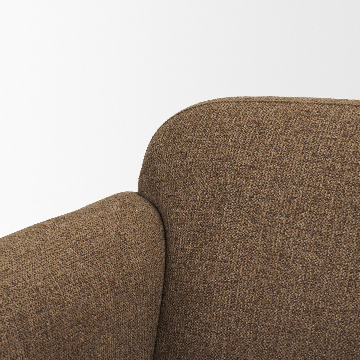 Close up detail of the curved backrest and woven mocha fabric texture on the Rowan chair.