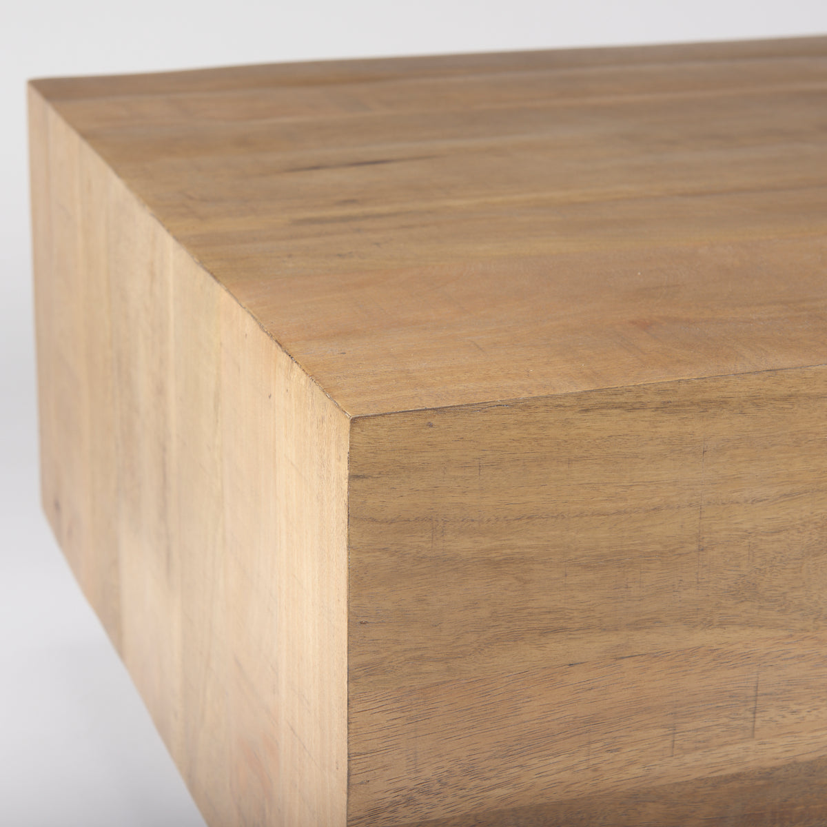 Close up detail of the Aero coffee table's sharp top corner and rich natural wood texture.