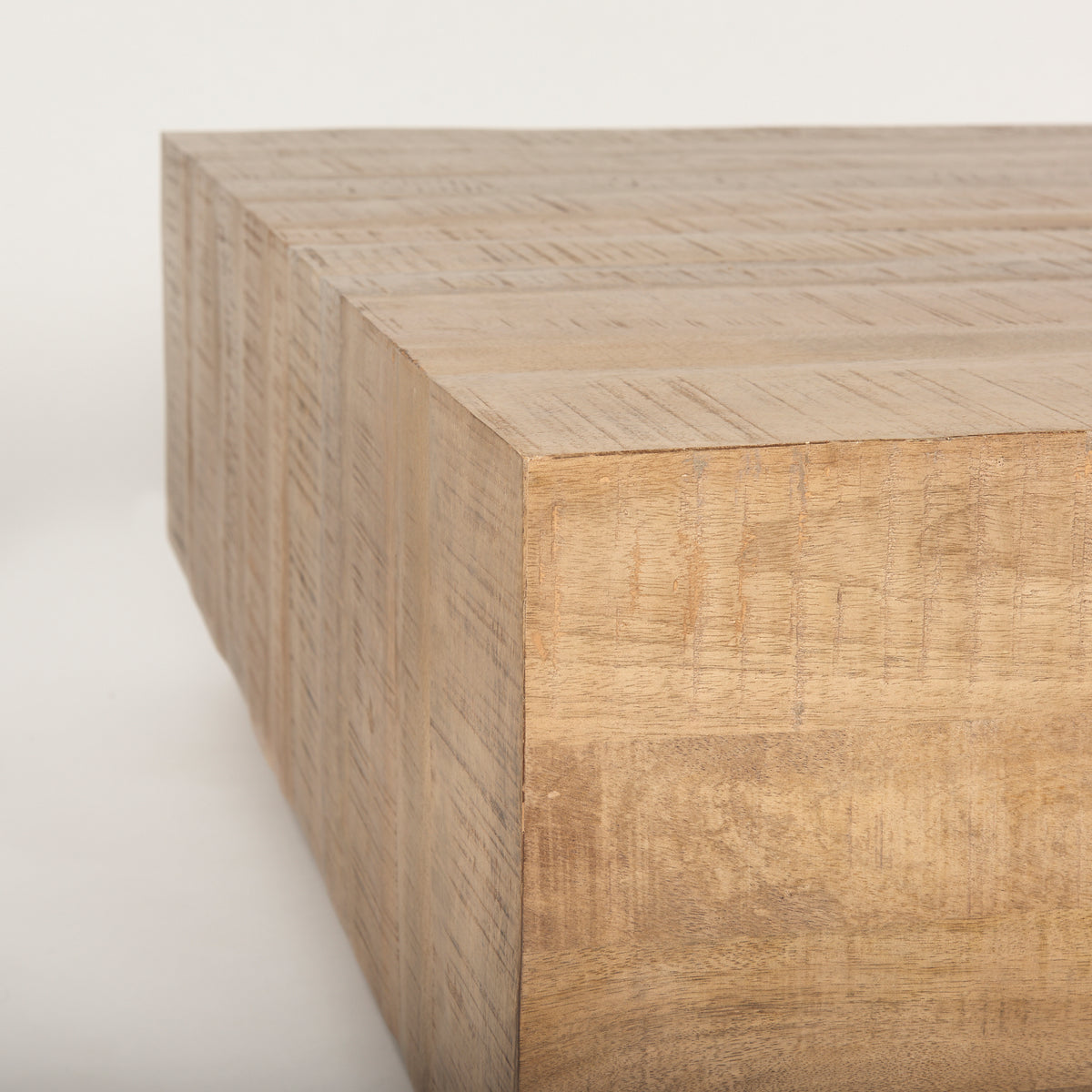 Macro close-up of the Aero table corner showcasing the natural mango wood grain and distressed finish.