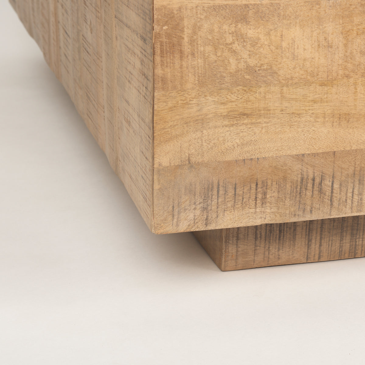 Close-up shot of the Aero coffee table base showing the sturdy recessed wood plinth construction.