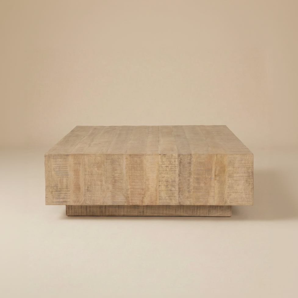 Front studio view of the Aero square plinth coffee table featuring a solid mango wood block design.