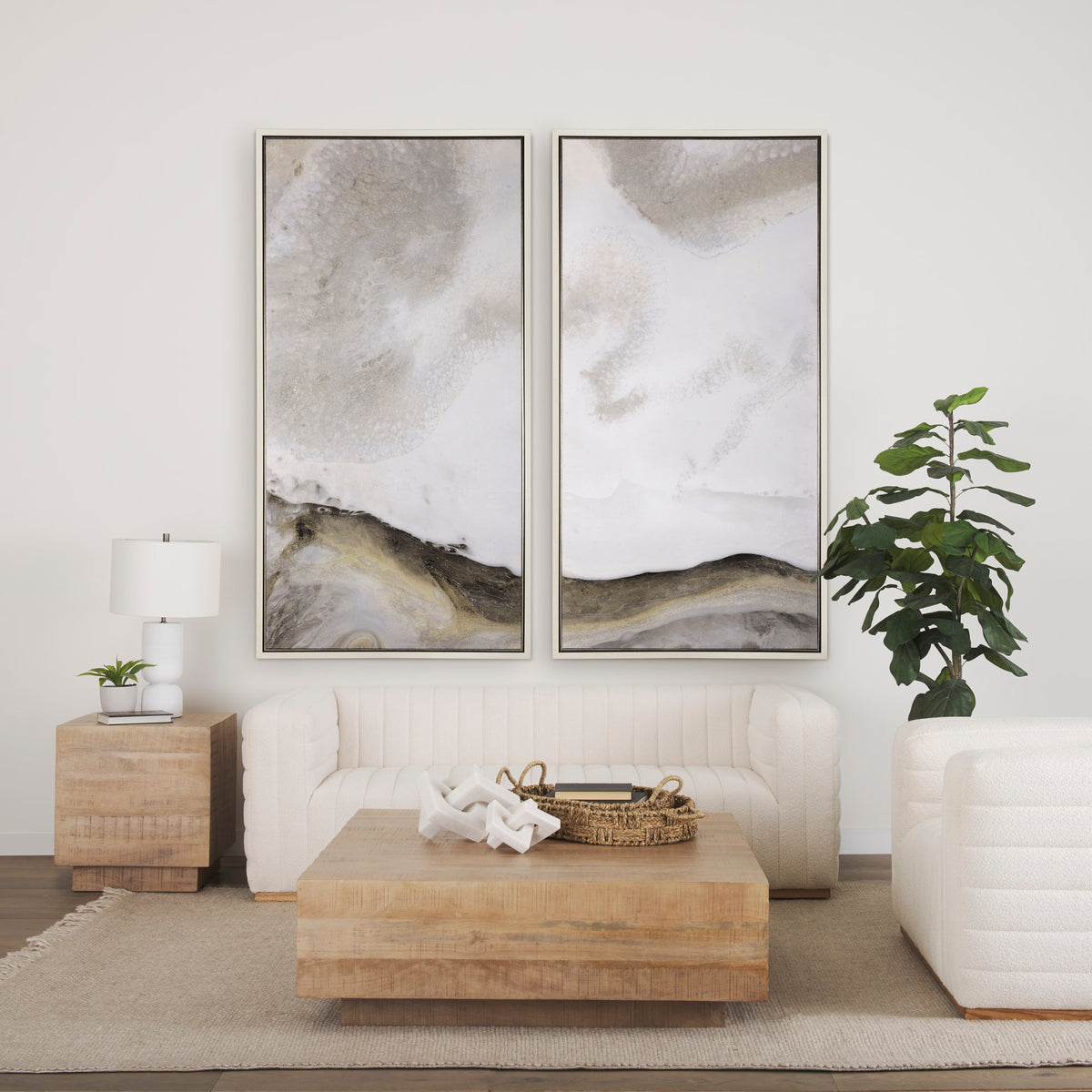 The Aero square coffee table styled in a minimalist living room with a white sofa, neutral rug, and large abstract art.