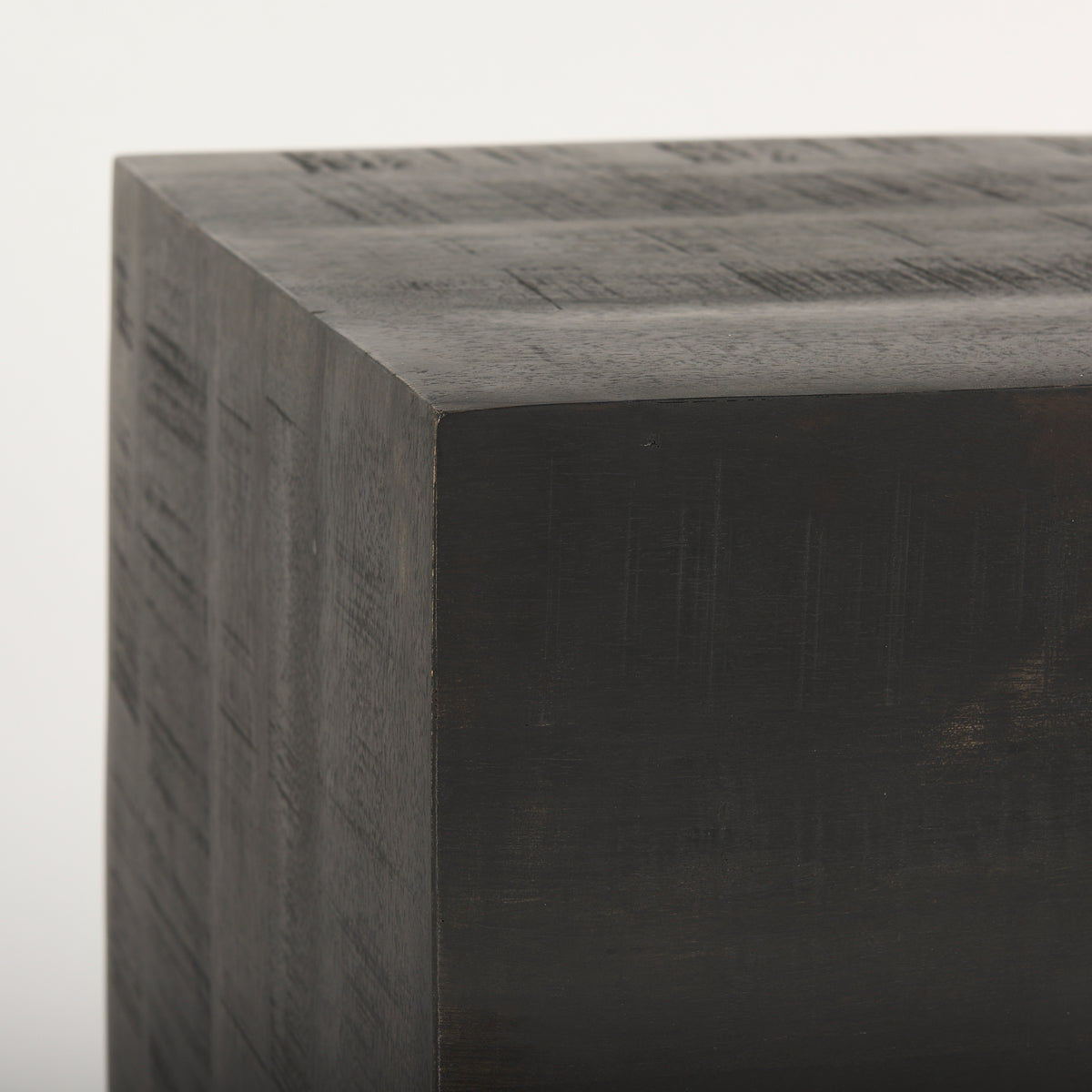 Dark brown solid wood block with a textured surface on a white background