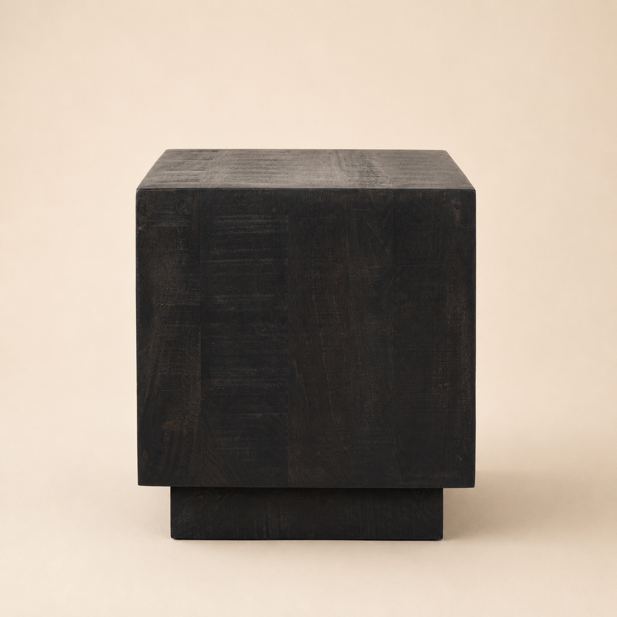 Dark brown cube-shaped side table on a beige background