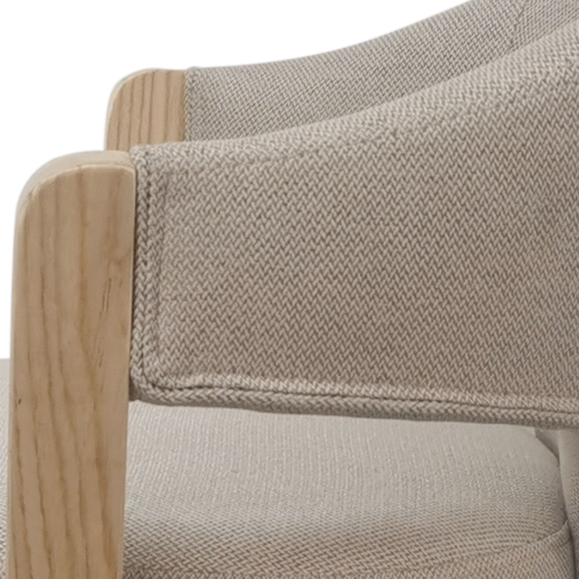 Close-up of a chair with beige fabric and wooden armrests on a white background