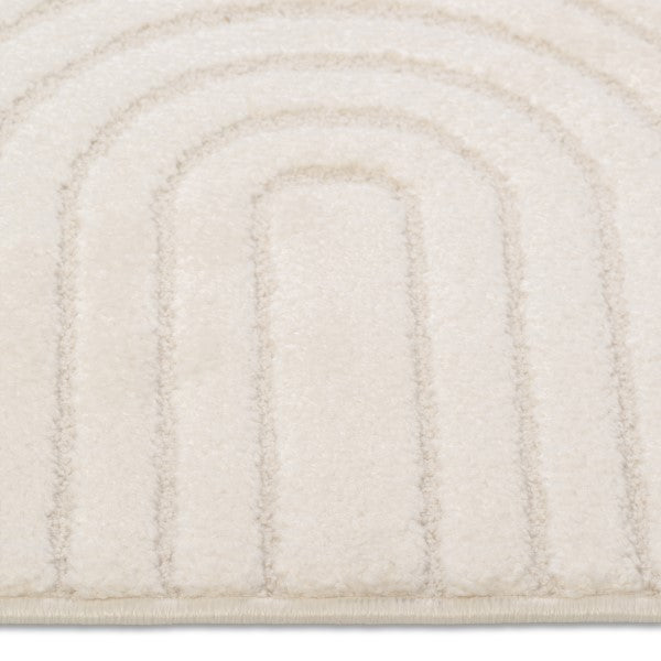 Close-up of a textured beige rug with concentric circular pattern