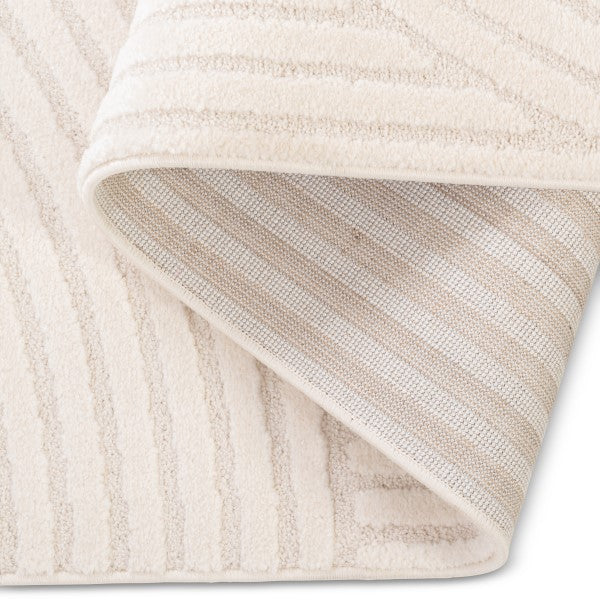 Close-up of a textured beige rug with a soft finish.
