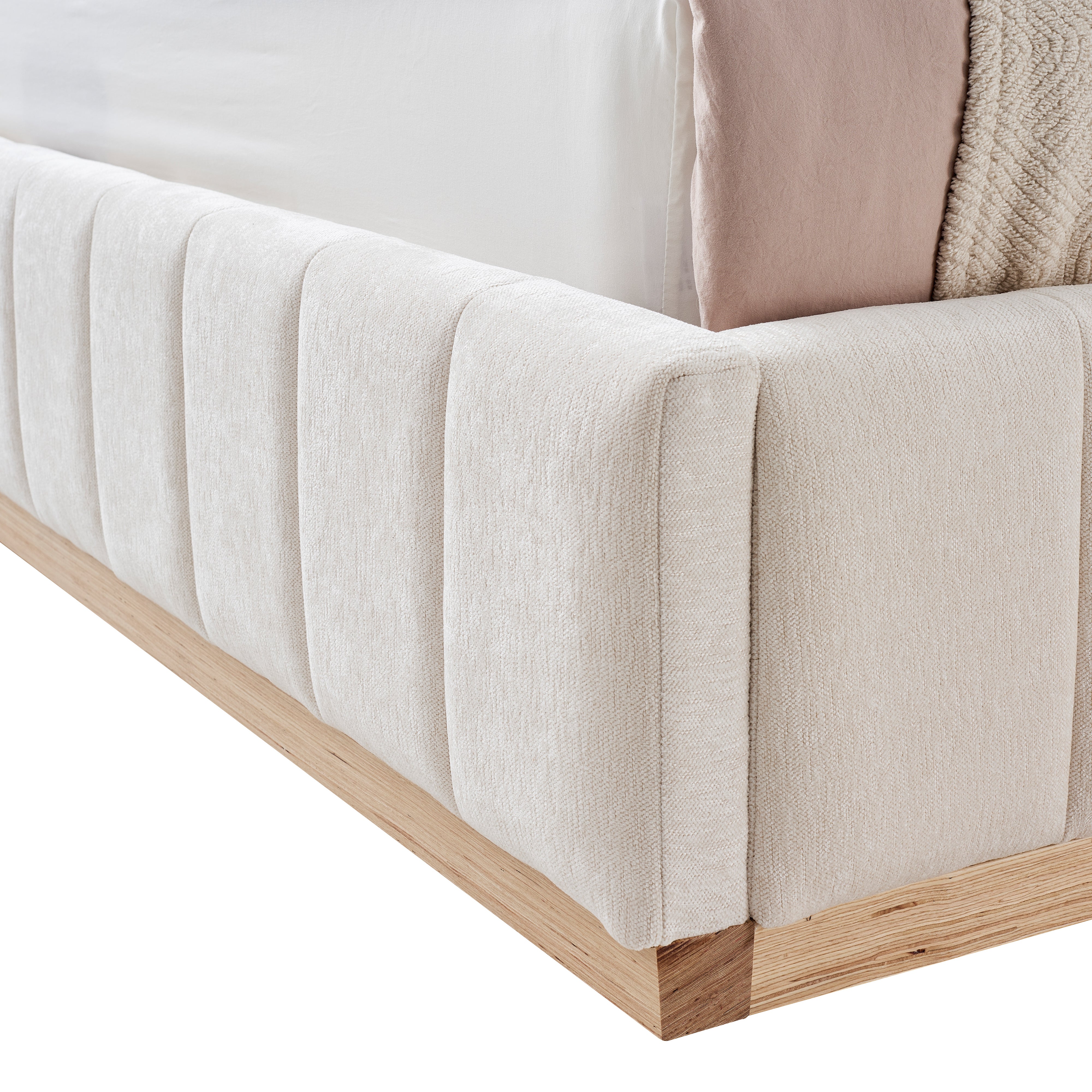 Close-up of a tufted footboard upholstered bed with solis ash wood base on a white background