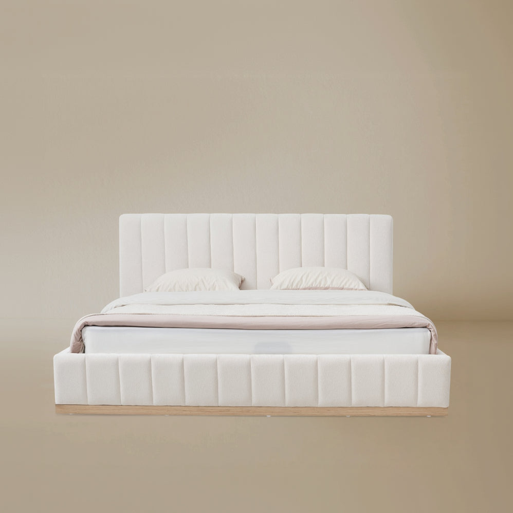 Beige linen bed with ash wooden frame against a beige background