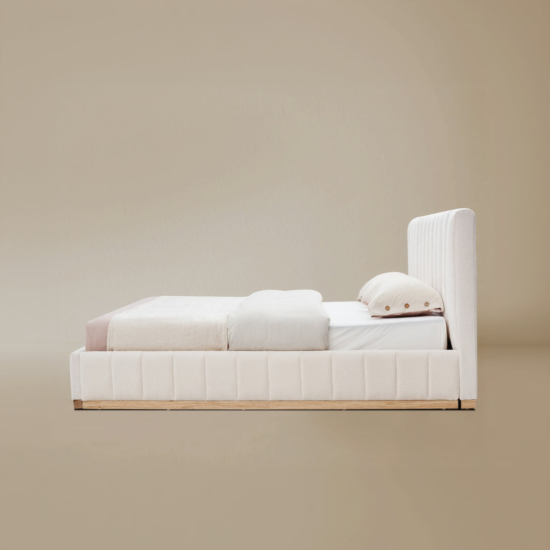 Side view of the Alora Beige linen bed with ash wooden frame against a beige background