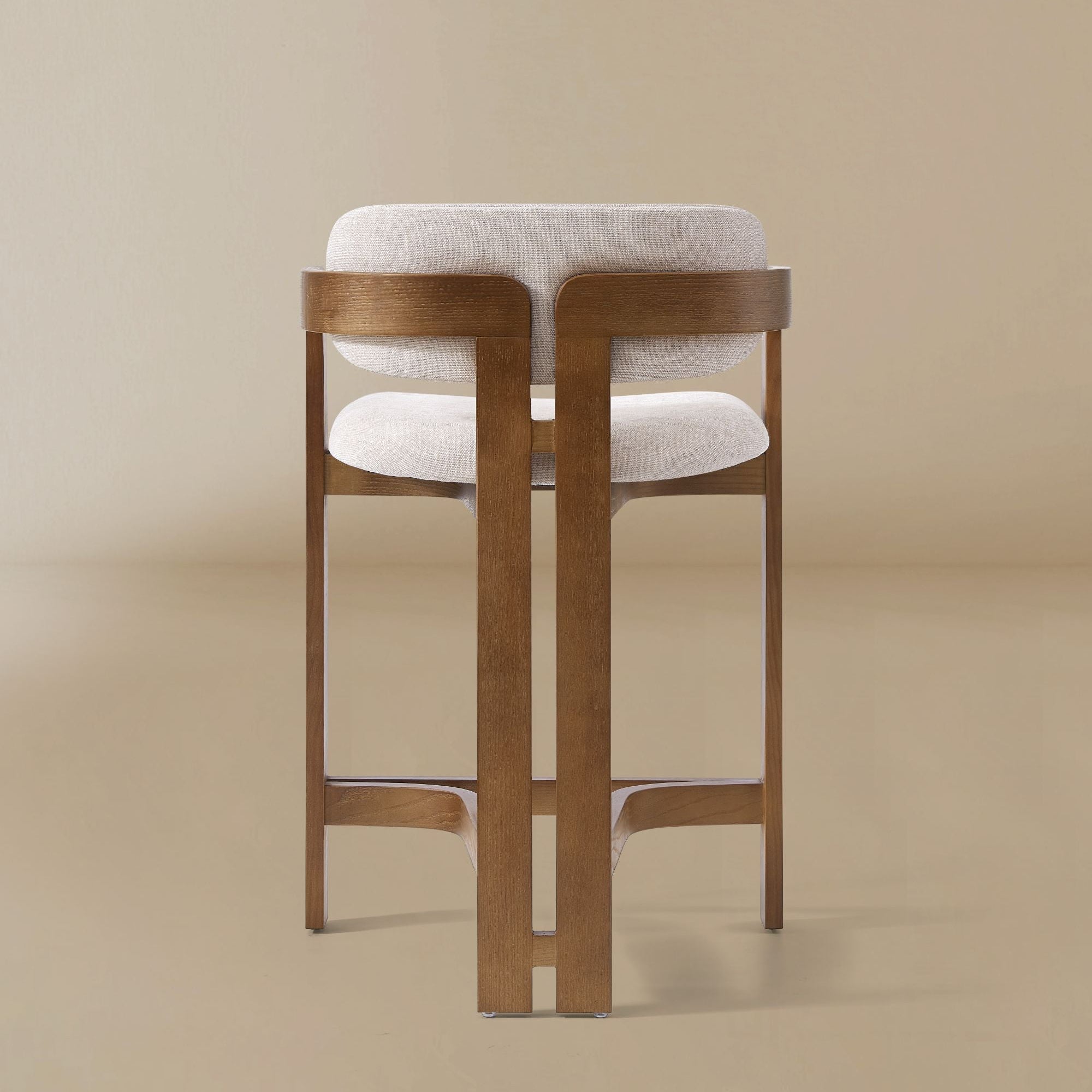 Ash wood counter stool with linen cushioned seat and backrest on a beige background