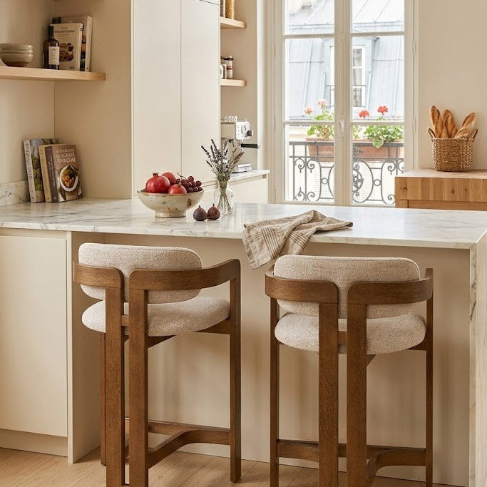 Modern kitchen with marble island, Amica counter stools, and decorative elements.