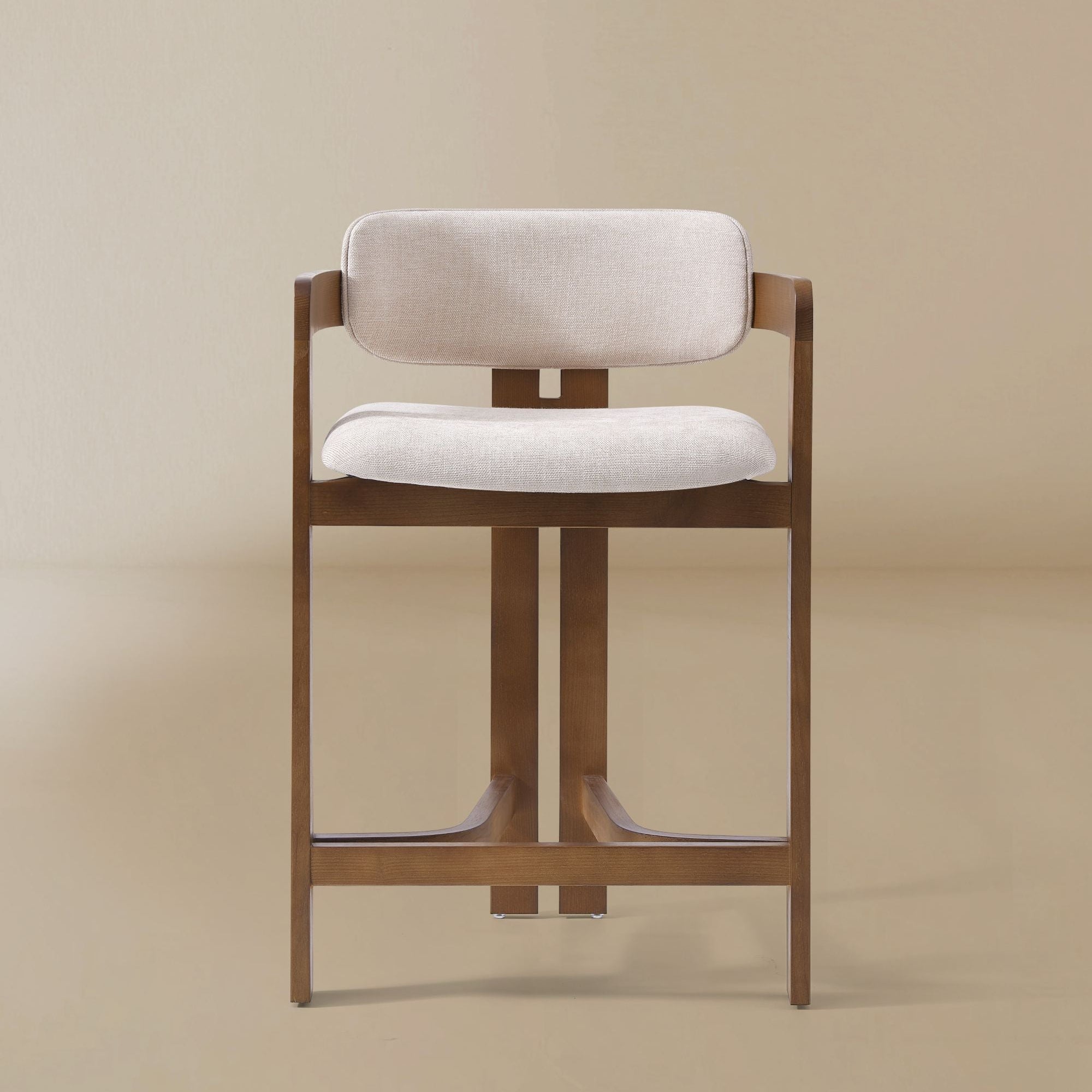 Ash wood counter stool with linen cushioned seat and backrest on a beige background