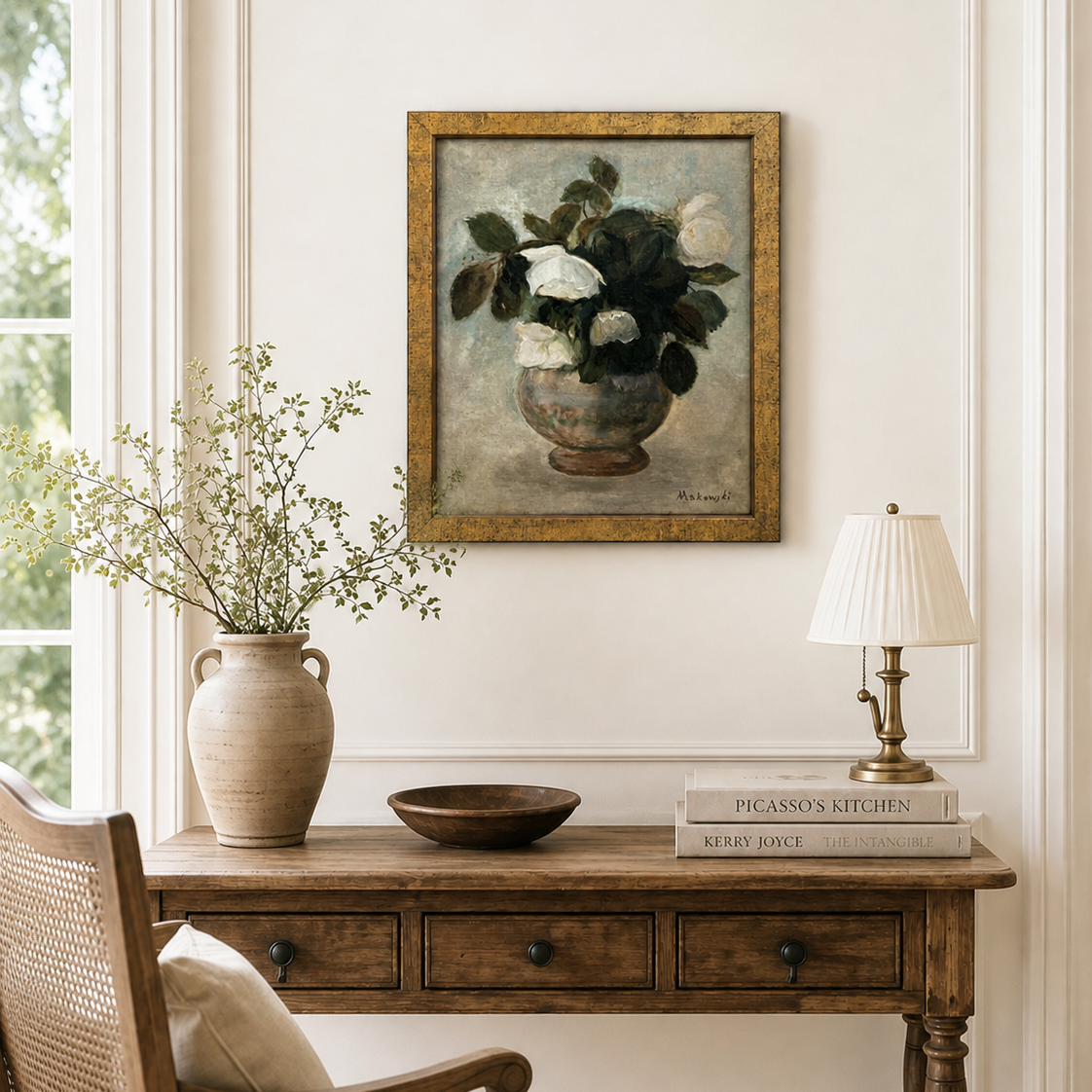 Nestled corner of a room with a wooden desk, chair, lamp, and framed artwork.