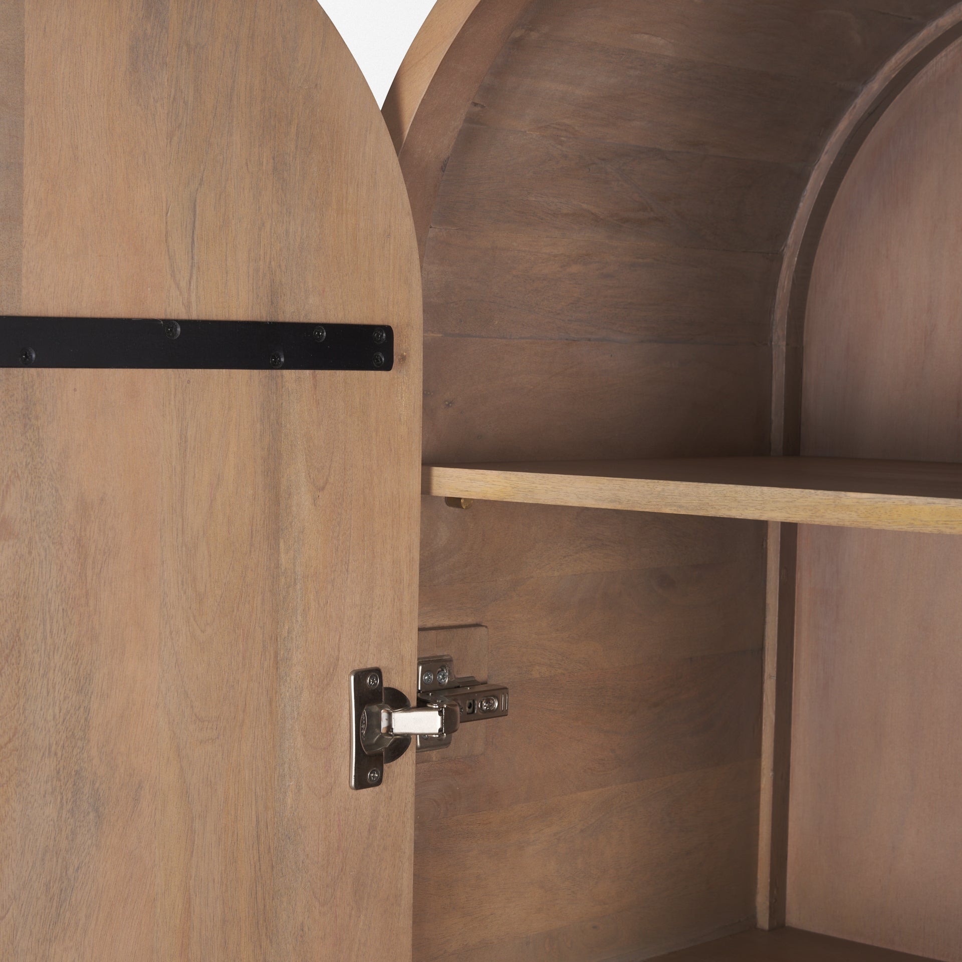 Interior detail of Arco curio cabinet showing adjustable shelf pegs and sturdy metal door hinge.