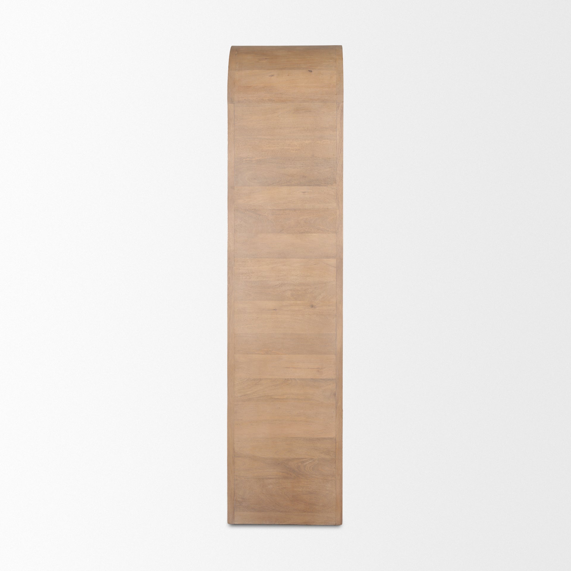 Side profile view of the Arco curio cabinet showing the smooth mango wood grain and waterfall curve.