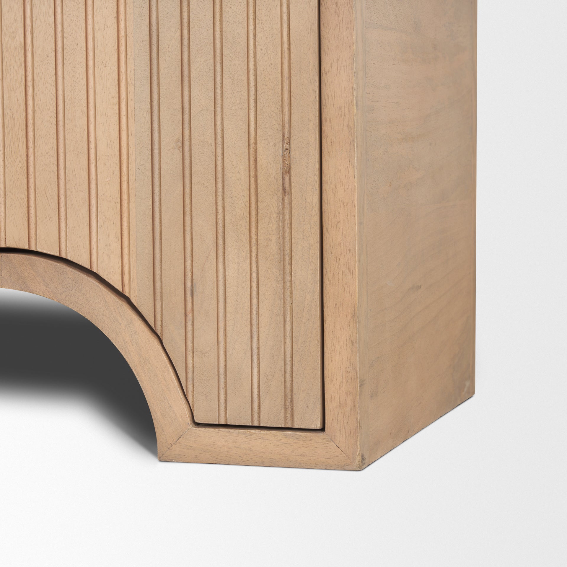 Close up detail of the Arco sideboard showing the intricate routed geometric lines and rounded corner base.