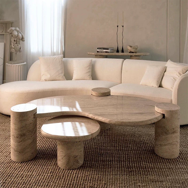 Close up view of the Ardea coffee table set showing the natural beige travertine stone texture and tiered design.