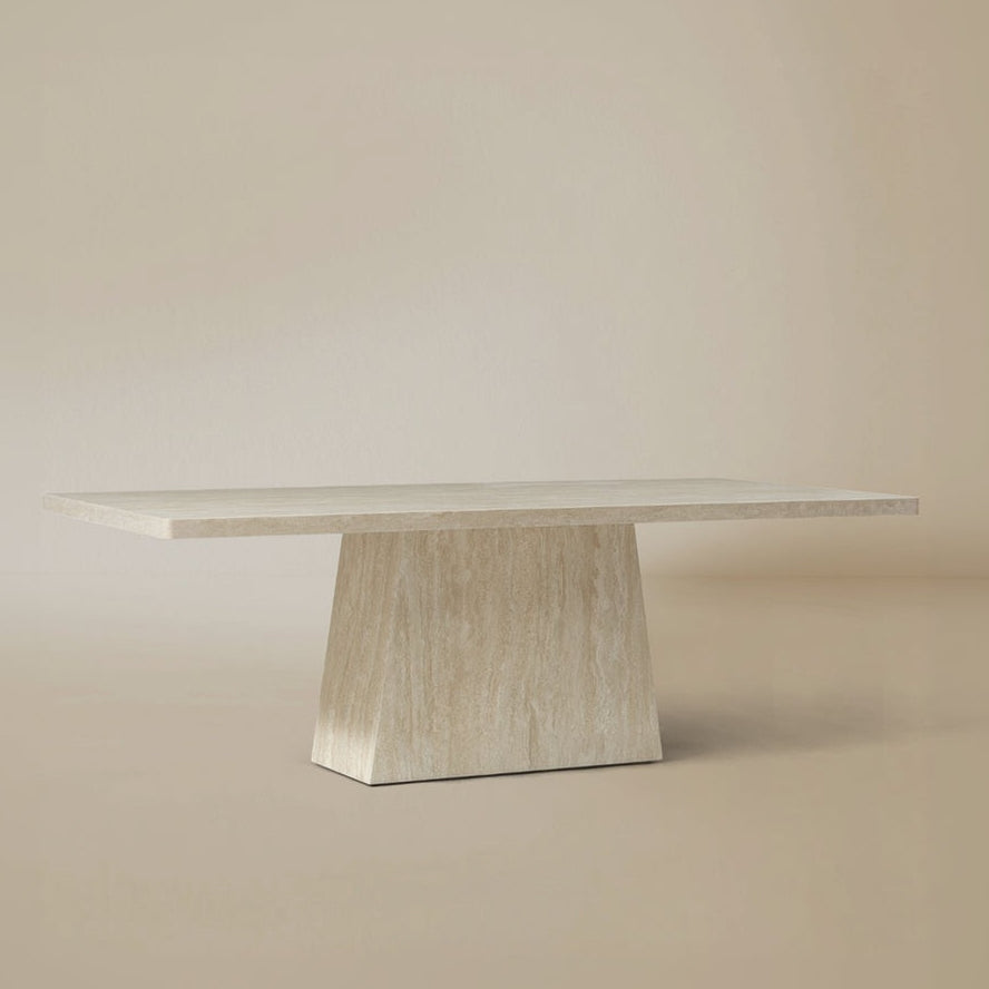 Angle view of the Ardella sintered stone dining table with sculptural pedestal basebackground