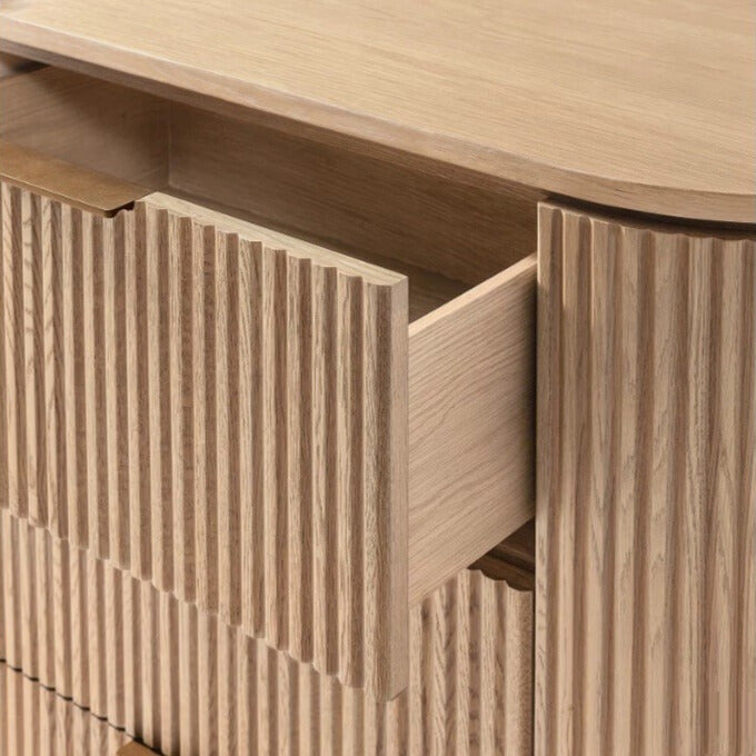 Close up of the Arden dresser with a drawer open, showing the solid wood construction, smooth glides, and ribbed texture detail