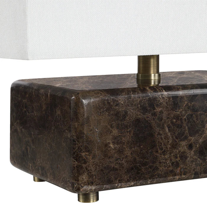 Marble lamp base with brass accents on a white background