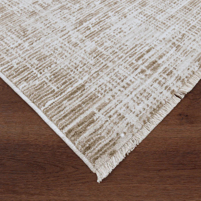 Textured beige rug on a wooden floor