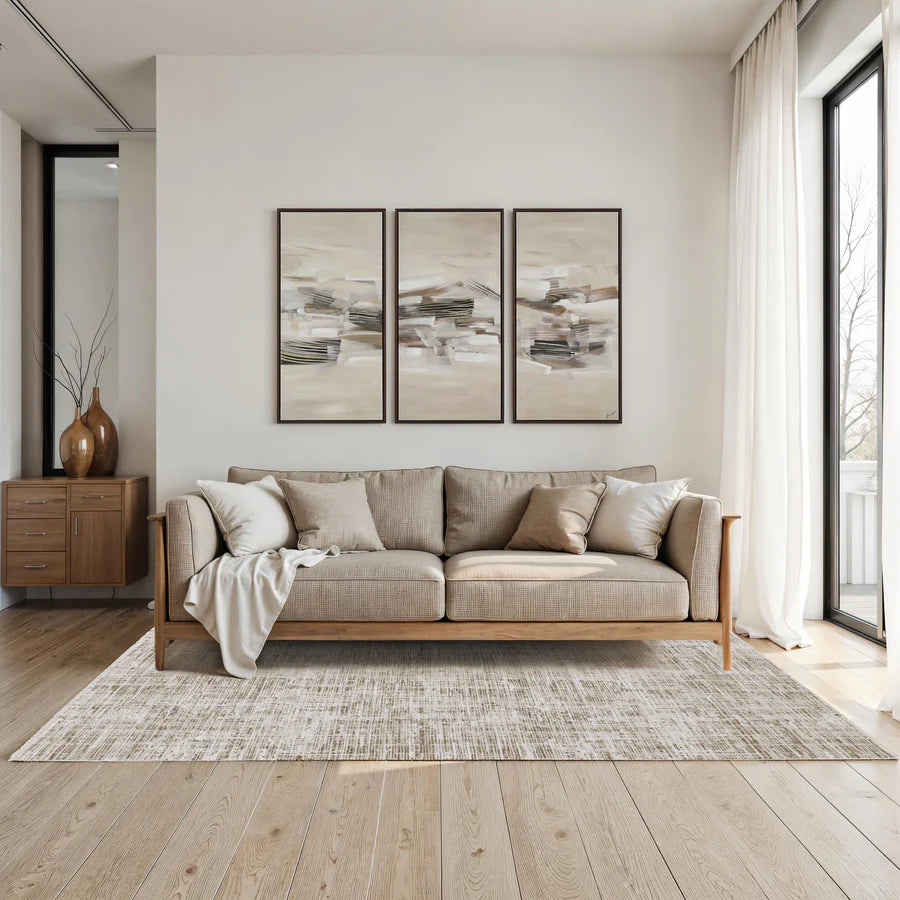 Modern living room with a beige sofa, abstract art, and wooden sideboard.