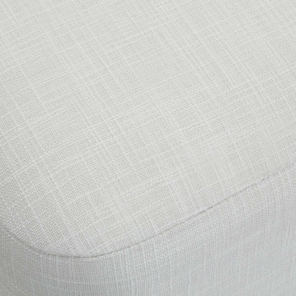 Close-up of the textured white linen upholstery on the Aurelie Linen Accent Stool.