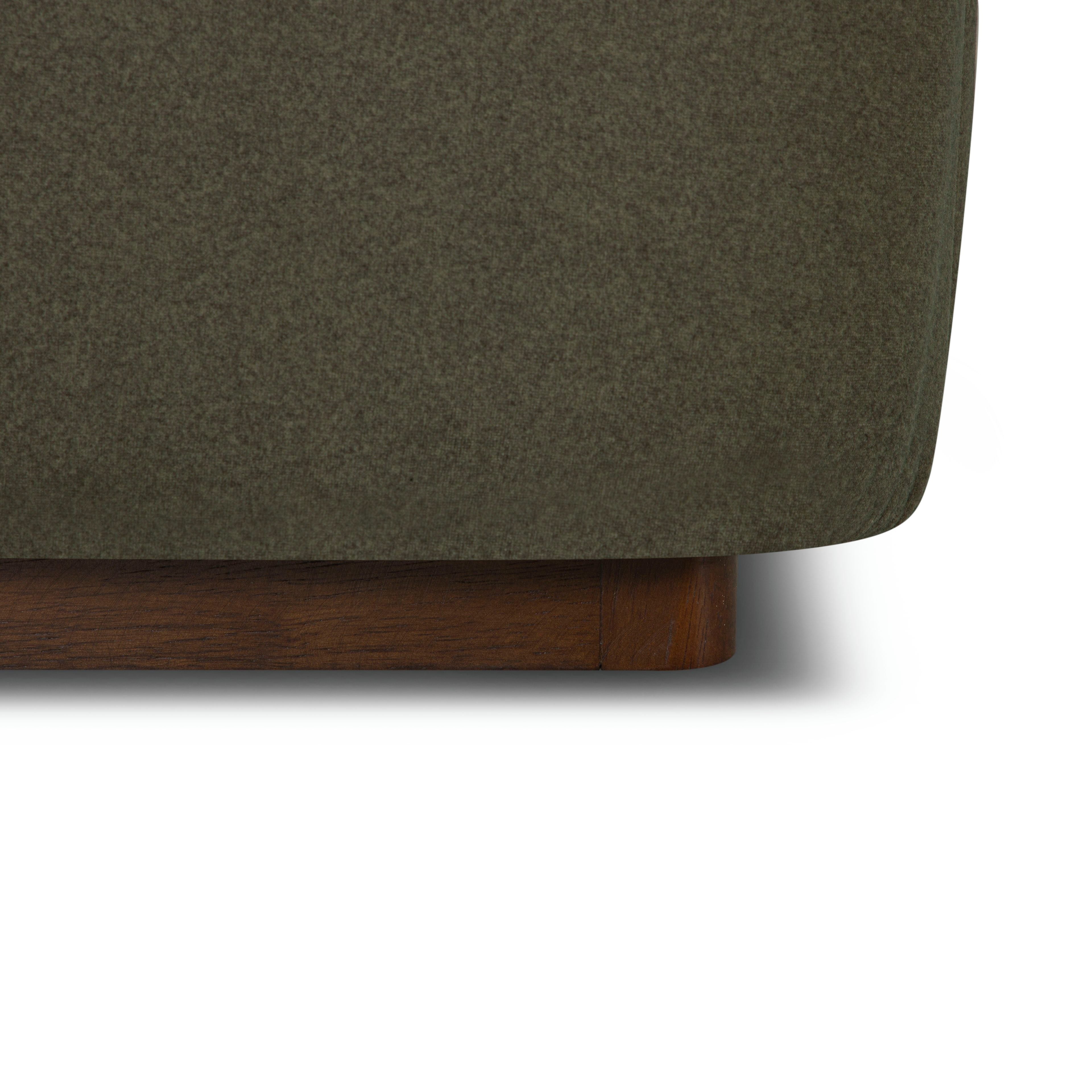Close-up of the Aveline Velvet Bed with a wooden base on a white background