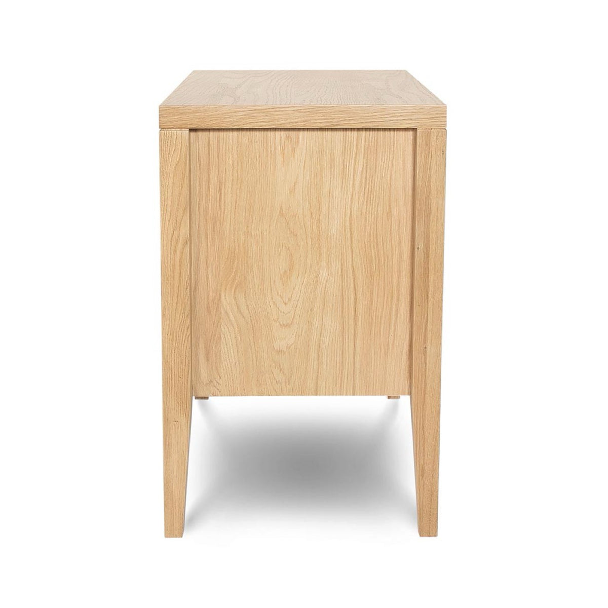 A direct side profile of the Beaumont 3-Drawer Nightstand, showcasing the clean lines and the depth of the natural oak frame.
