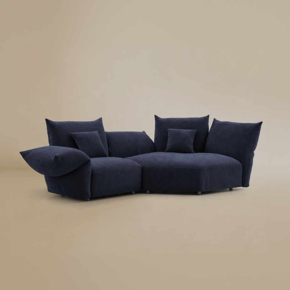 Navy blue sofa with multiple cushions on a beige background