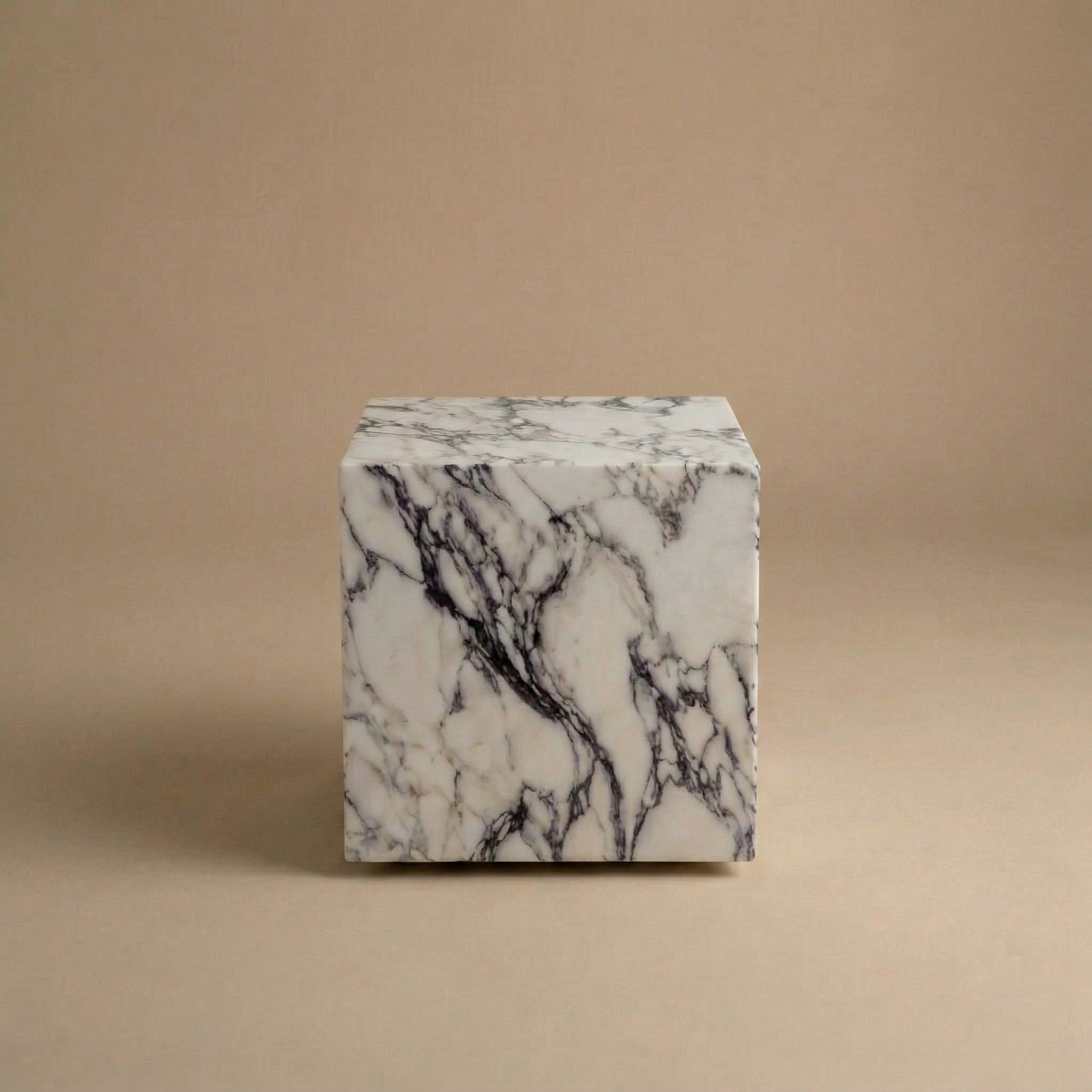 Marble-patterned cube on a beige background