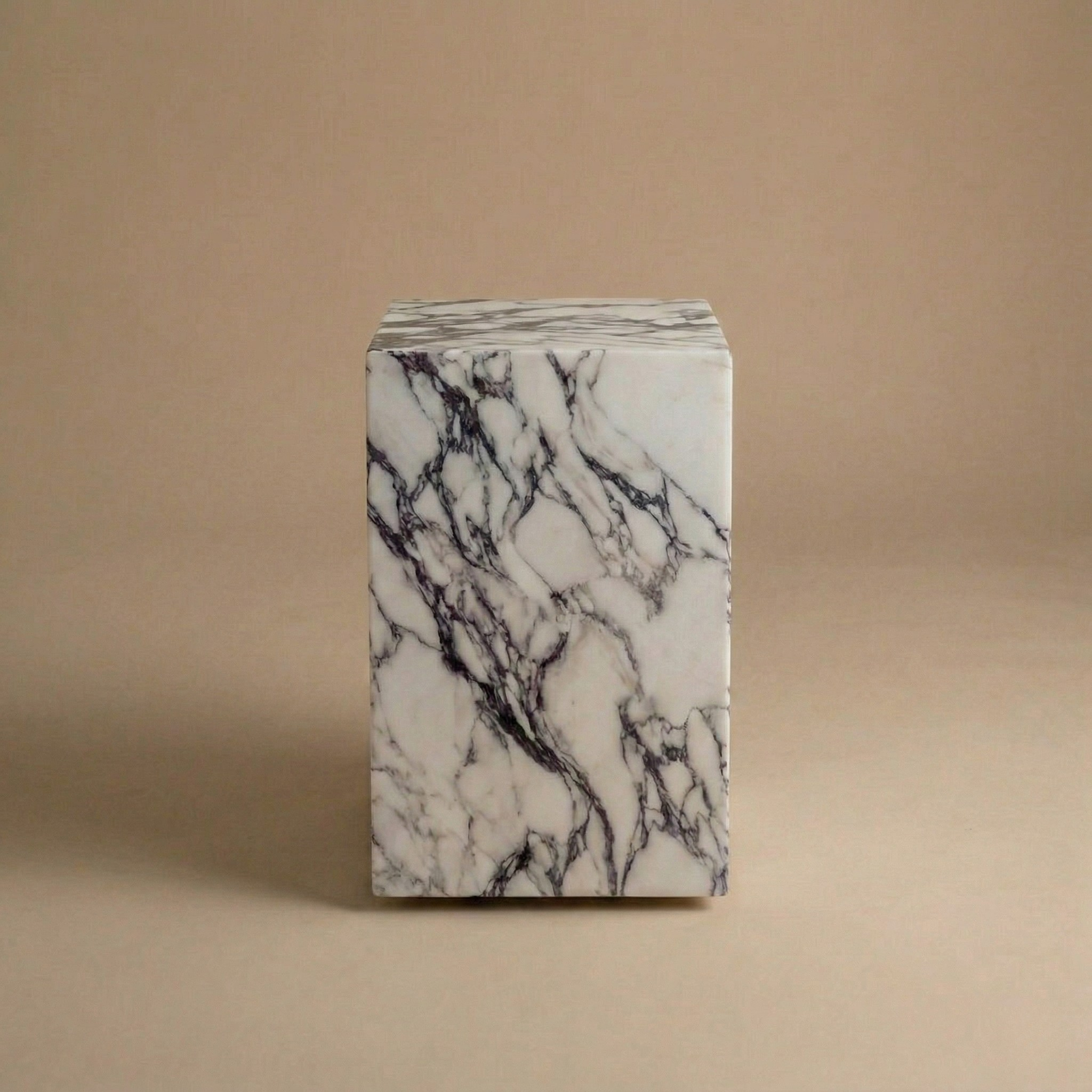 Marble-patterned cube on a beige background