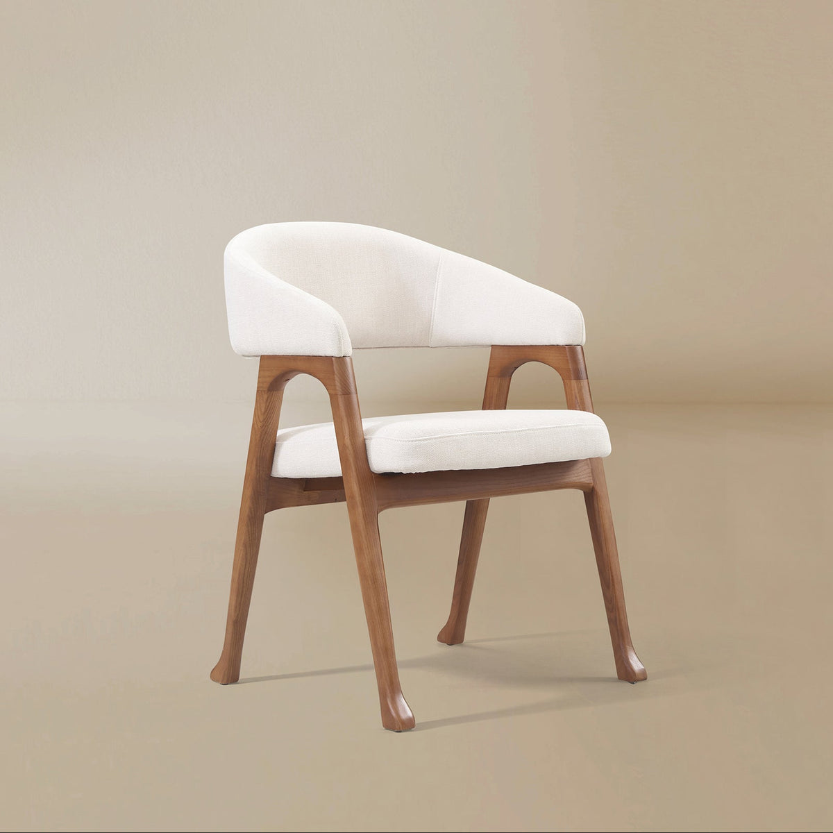 Angled front view of the Calira linen dining chair showing its curved upholstered arms and arched openings in the ash wood veneer frame
