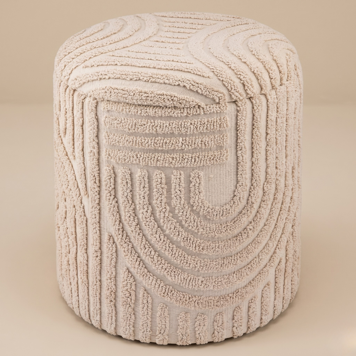 Textured beige ottoman on a beige background