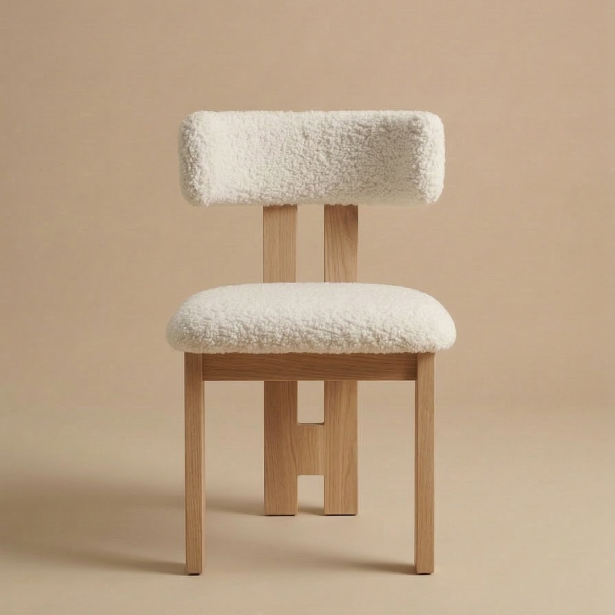 Front view of the modern dining chair featuring a natural light ash wood frame with a central back leg and a textured white bouclé seat featuring the Casper...