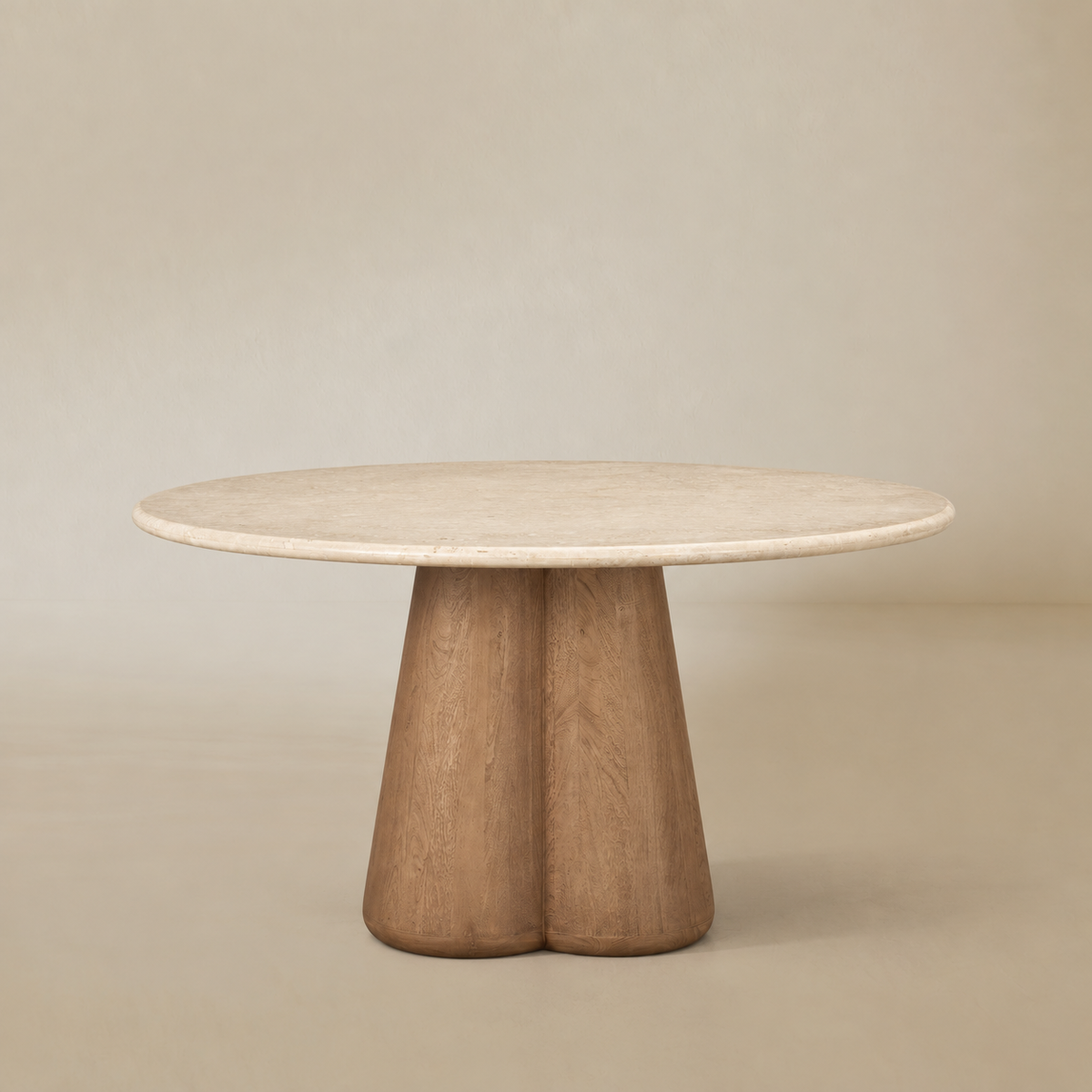 Caspia Botticino marble round dining table on a warm beige studio background