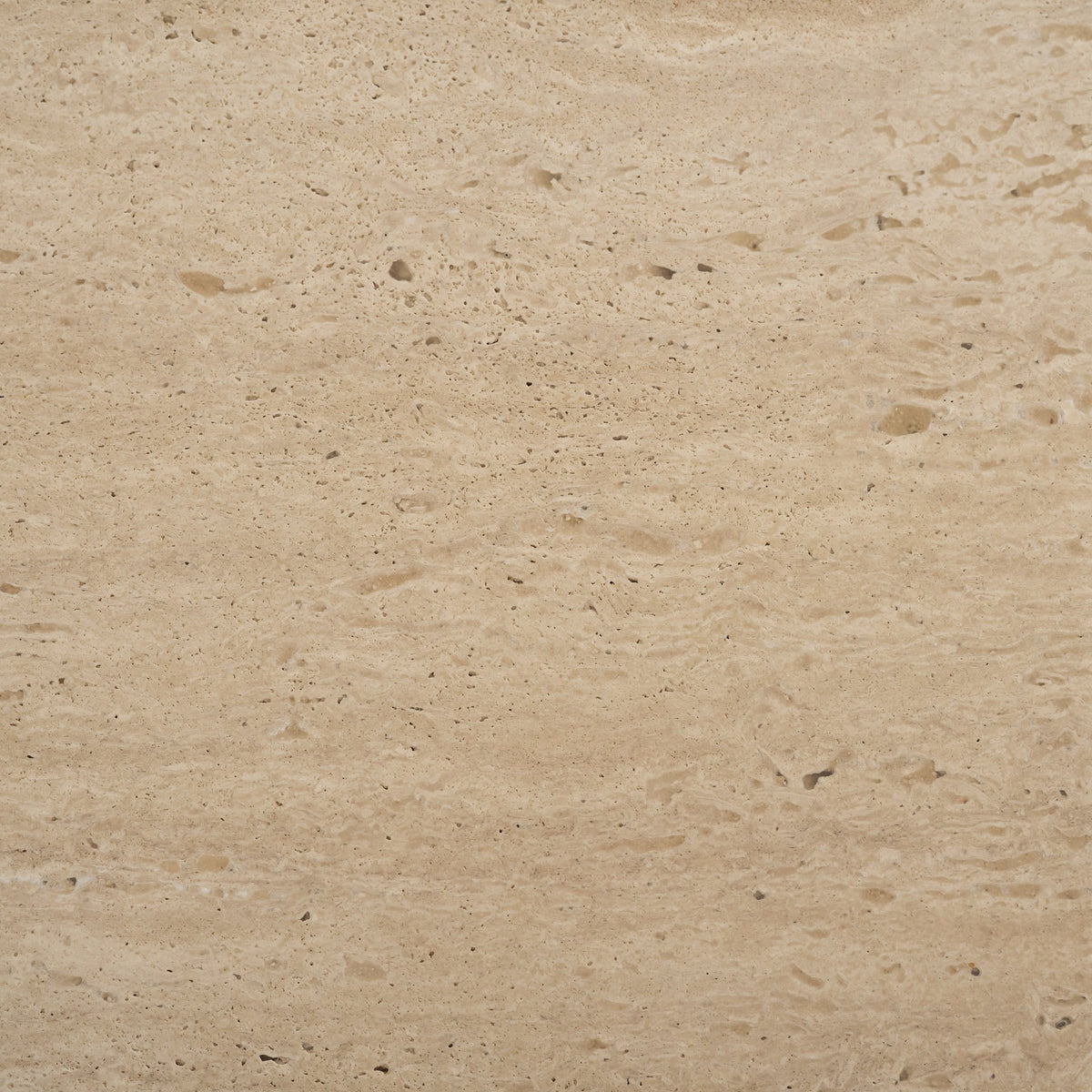 Material swatch showing the beige travertine stone used on the Cavelle Coffee Table top.