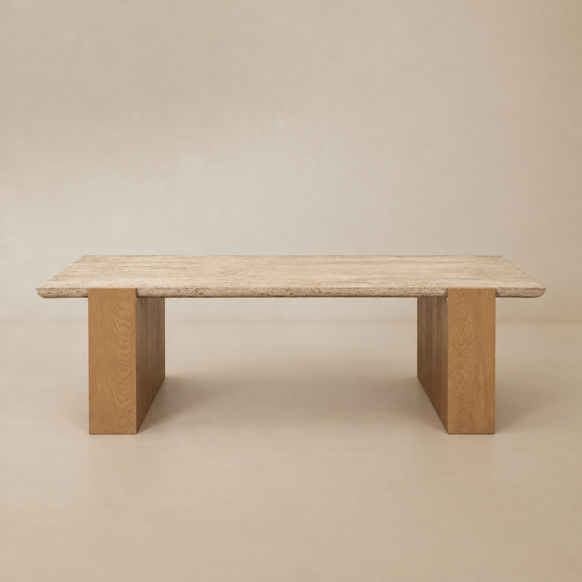 Front studio view of the Cavelle Travertine & Oak Coffee Table with a rectangular beige travertine top and light brown oak blade legs on a warm beige background.