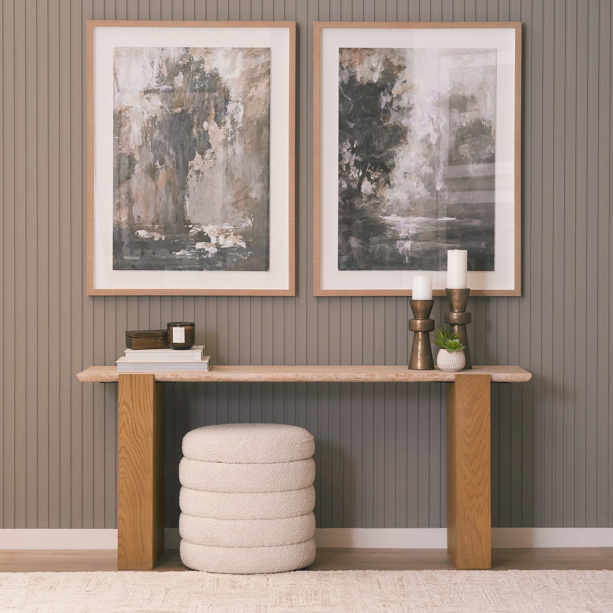 Cavelle Travertine & Oak Console Table styled against a paneled wall with framed artwork and neutral decor.