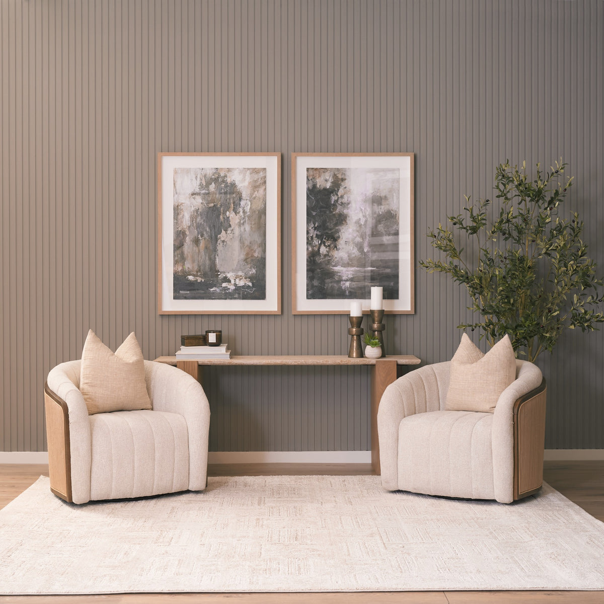 Wide room view featuring the Cavelle Travertine & Oak Console Table positioned behind two upholstered lounge chairs.
