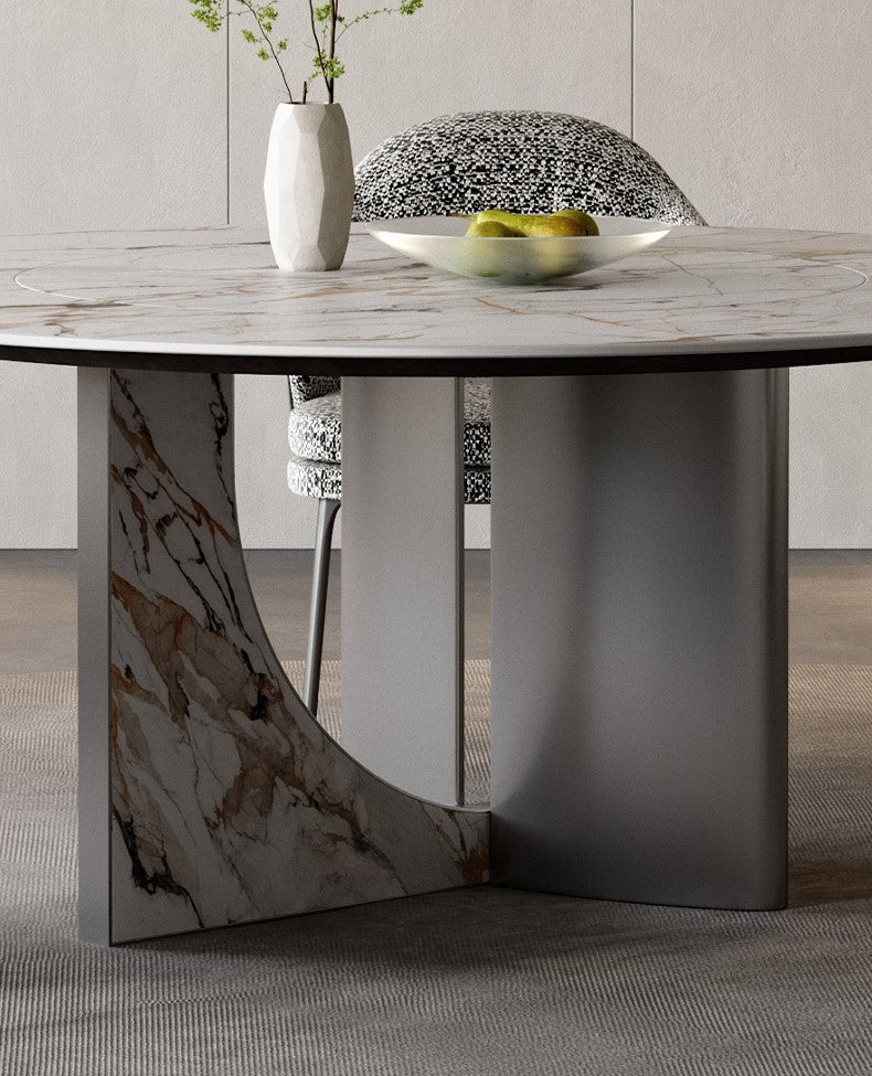 Close-up of Celestia Elegance round dining table showcasing marble-patterned top and stainless steel cross base with artistic detailing
