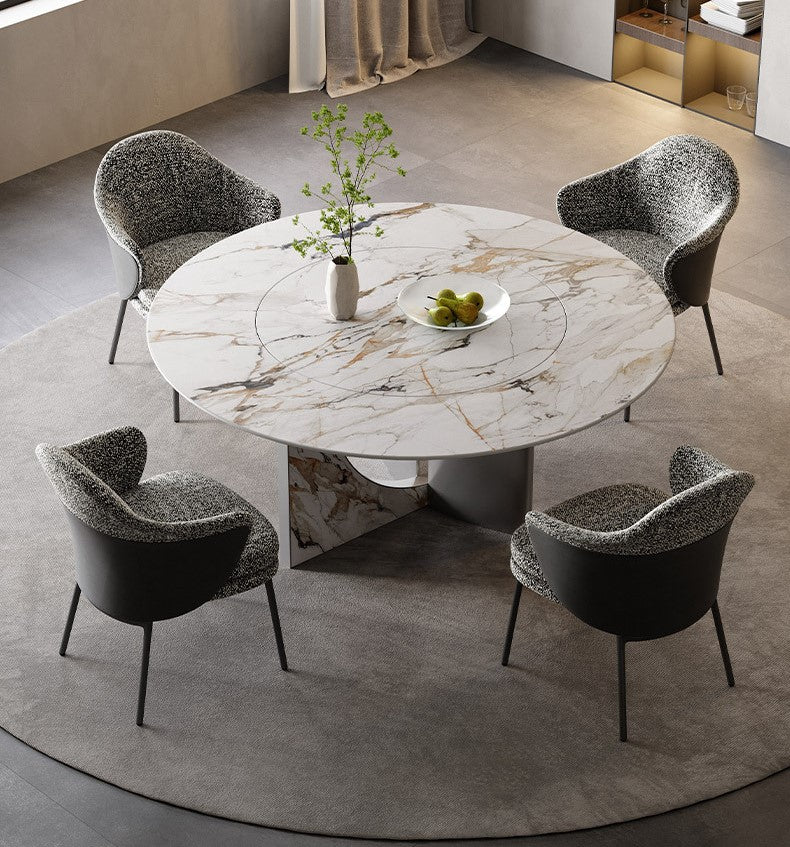 Celestia Elegance round dining table with marble-patterned top and stainless steel base styled with four upholstered chairs in a modern dining room