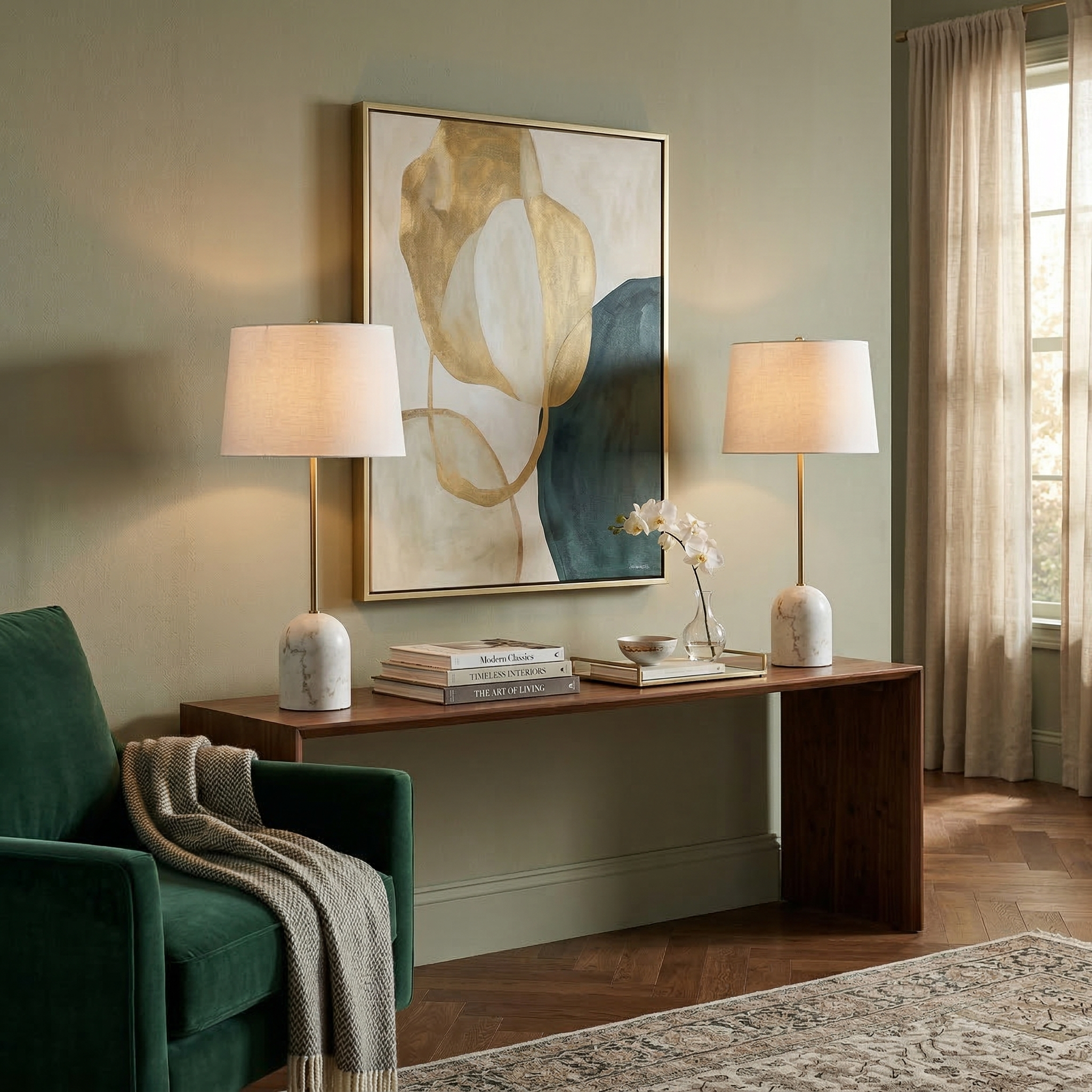 A set of two Celine marble and brass lamps styled on a long walnut console table in a contemporary living room.