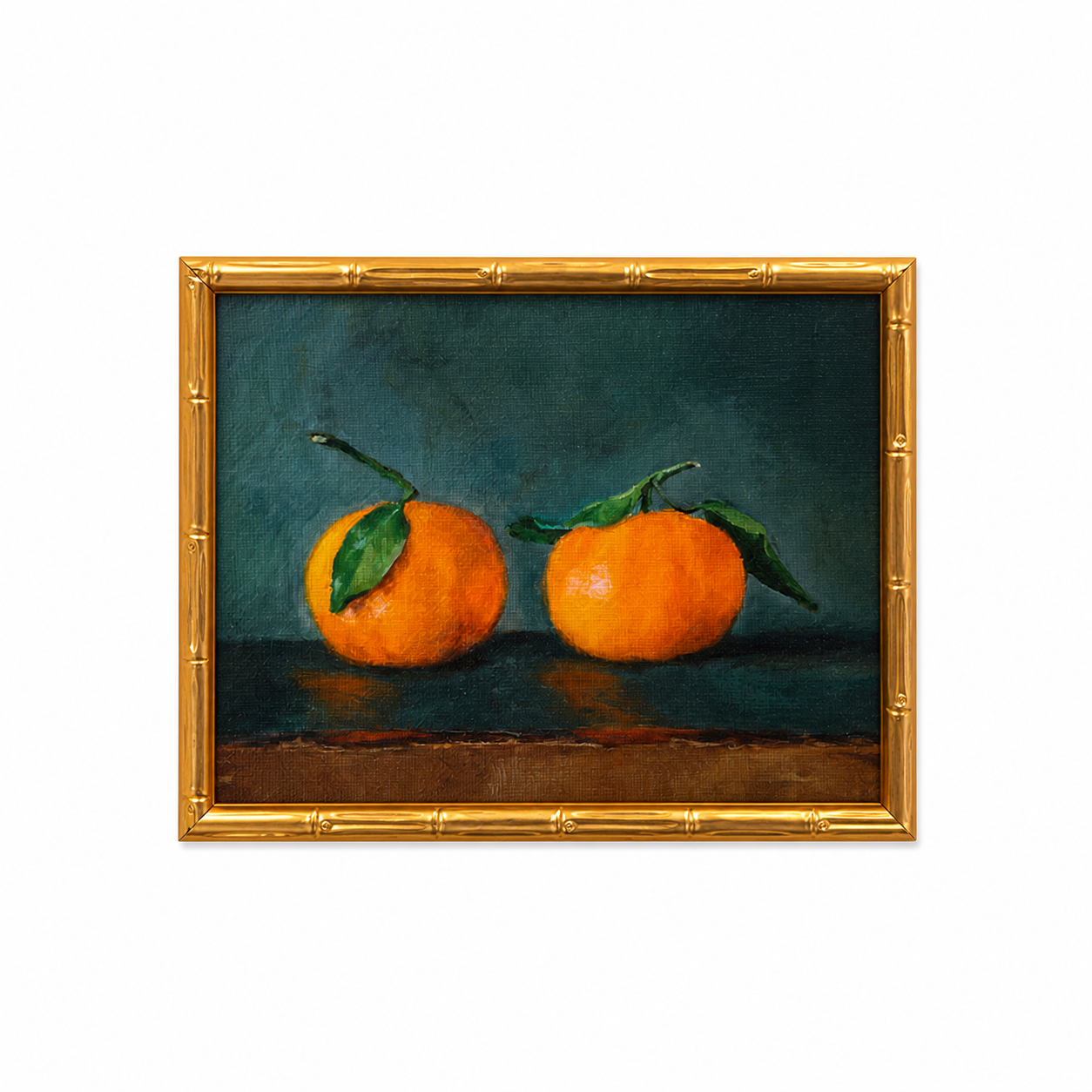 Painting of two oranges with green leaves in a gold frame on a white background