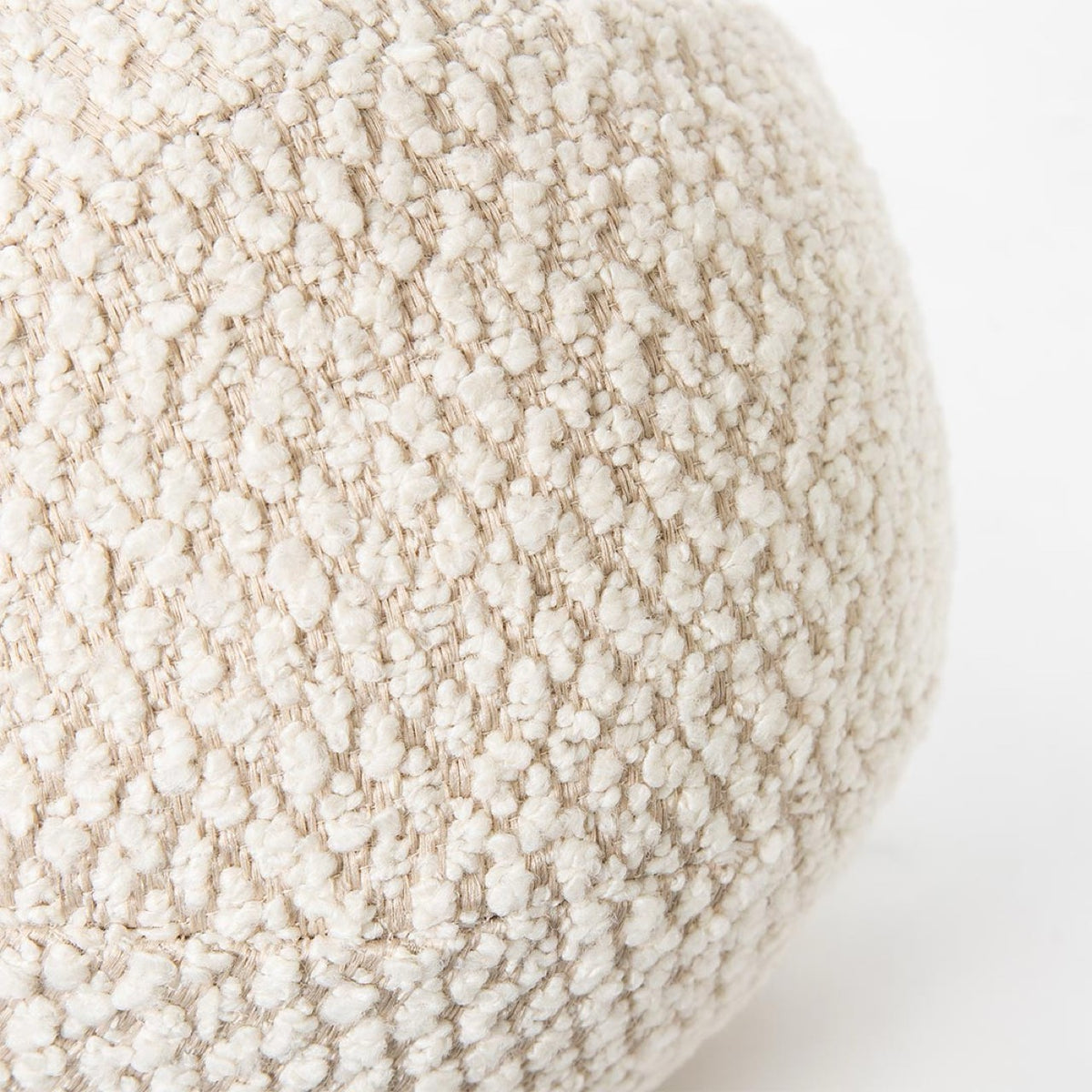 Macro close-up of the spherical Cloudline pillow showcasing its unique chunky honeycomb bouclé weave.