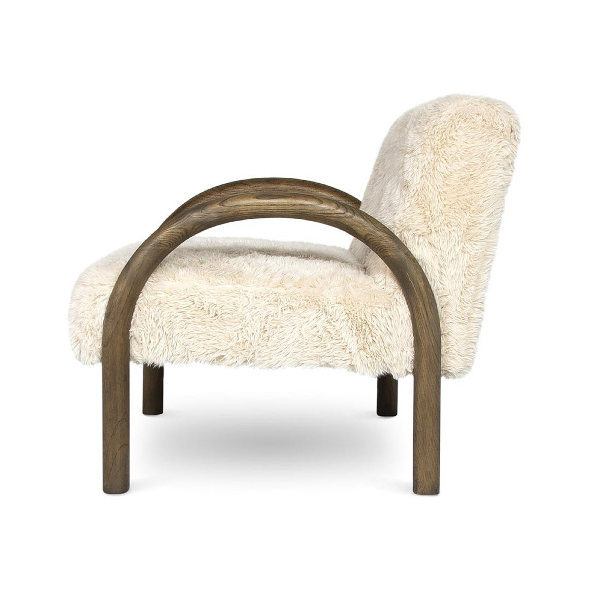 Side profile of the Coco faux fur chair showing the continuous curve of the wooden legs and arms.