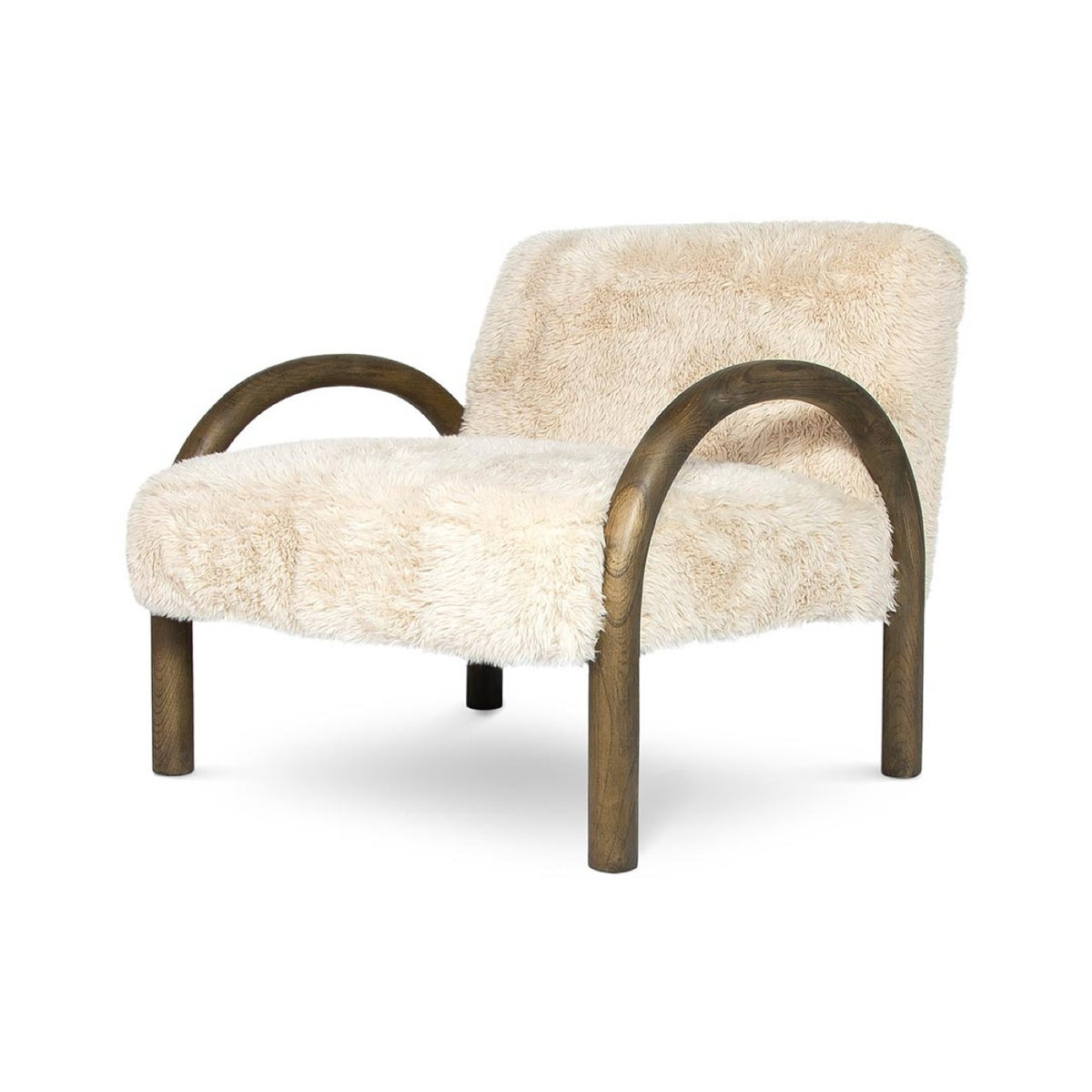 Angled studio view of the Coco faux fur chair highlighting its deep profile and sculptural arched wooden frame.