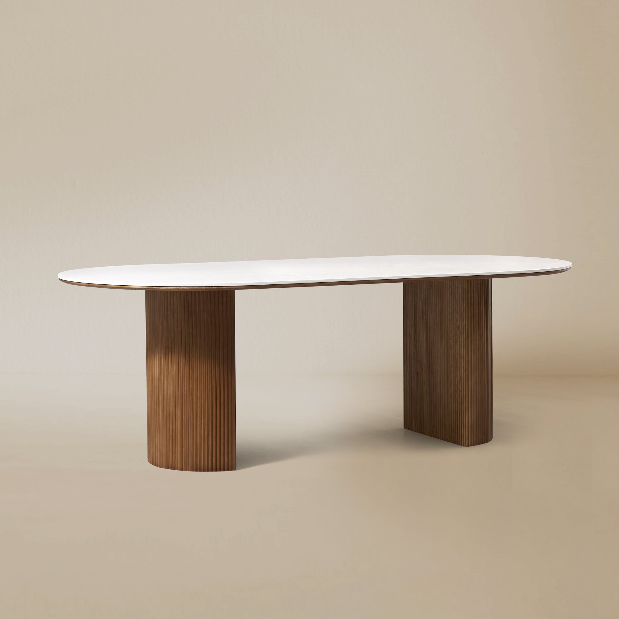 Angled view of the Crescent Grove Dining Table with fluted walnut bases