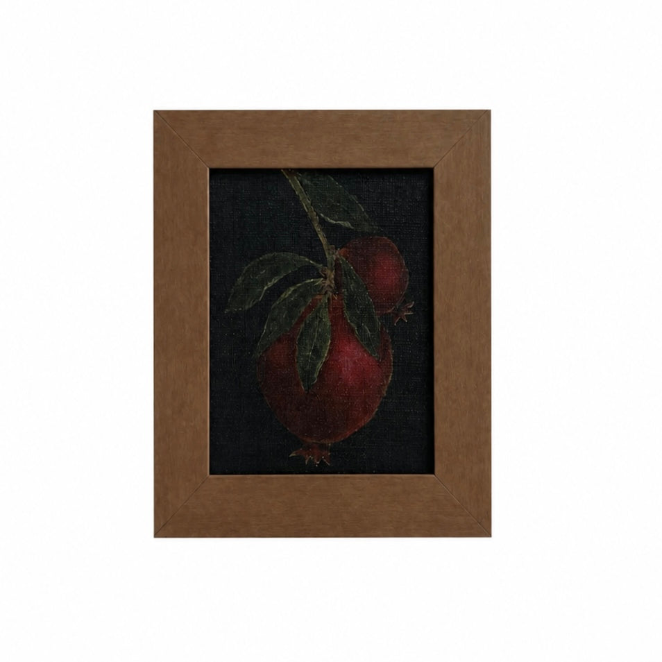 Framed artwork of a pomegranate on a dark background